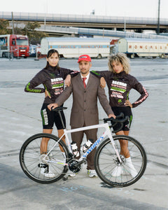 Naira and Agatha pose with Team Director Coco, wearing the Beyond Racing Dream team kit featuring moongem color way Specialized Aethos bike