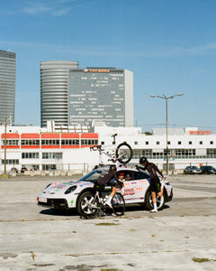 Racing Dream Team stretches around the team 911 Dakar while Team Director Coco gives advice.